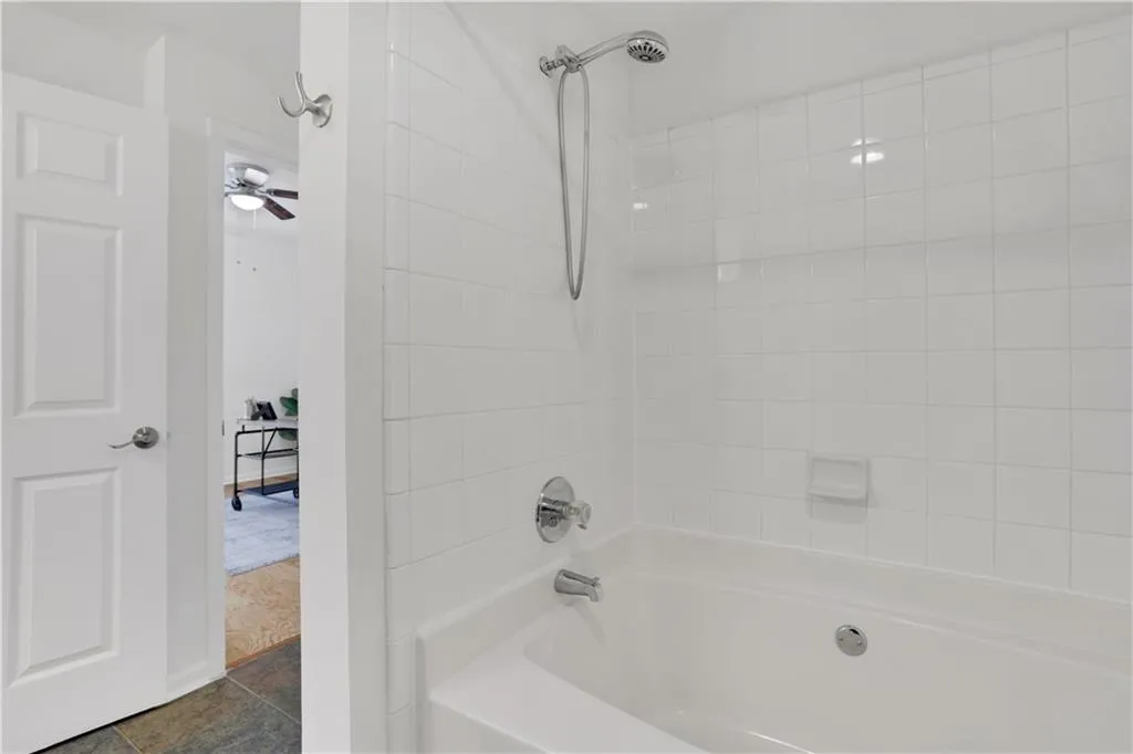 Full bathroom featuring bathtub / shower combination and a ceiling fan