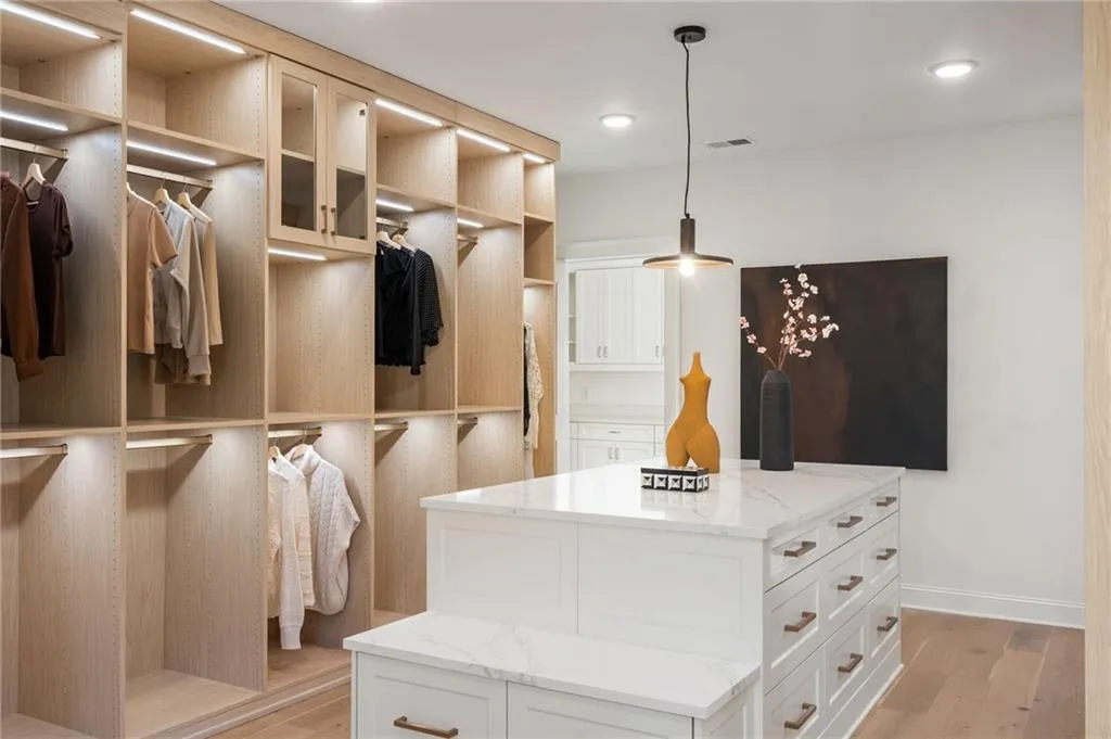 Walk in closet with light wood-type flooring and visible vents