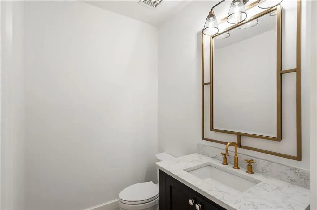 Bathroom with visible vents, vanity, and toilet