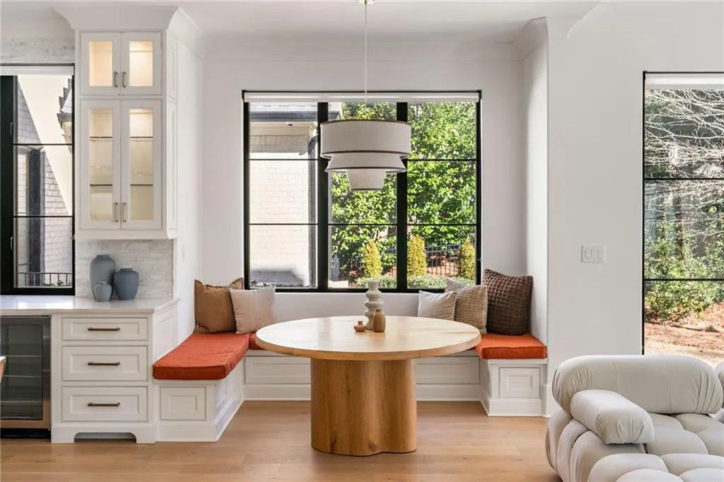 Living area featuring beverage cooler, ornamental molding, and light wood-style floors
