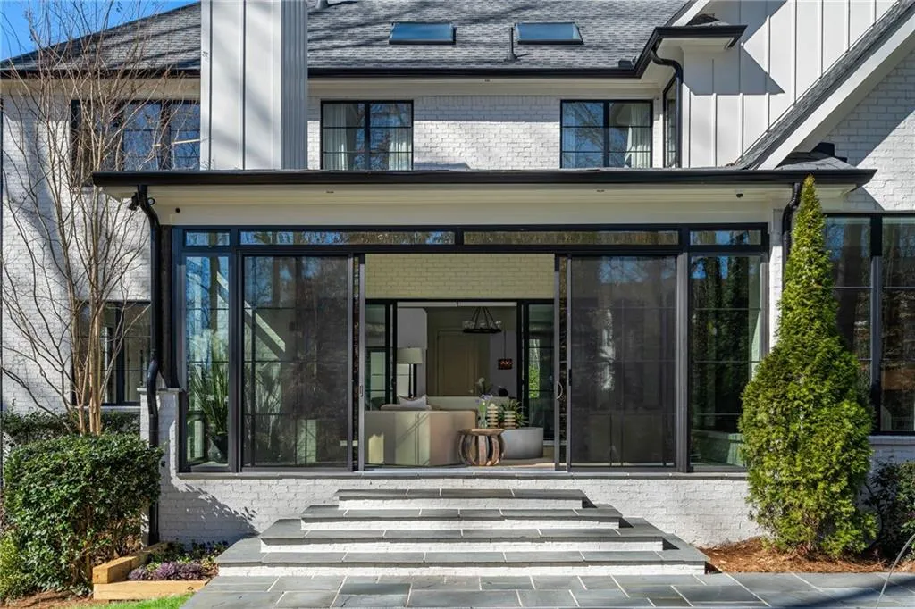 View of exterior entry featuring board and batten siding and brick siding