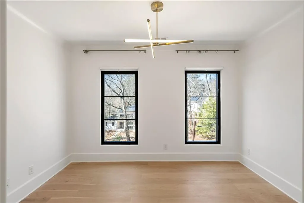 Unfurnished room with light wood-type flooring and baseboards