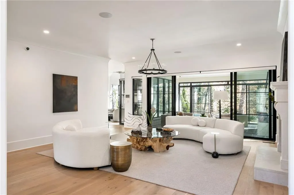 Living room with light wood-style floors, recessed lighting, and baseboards