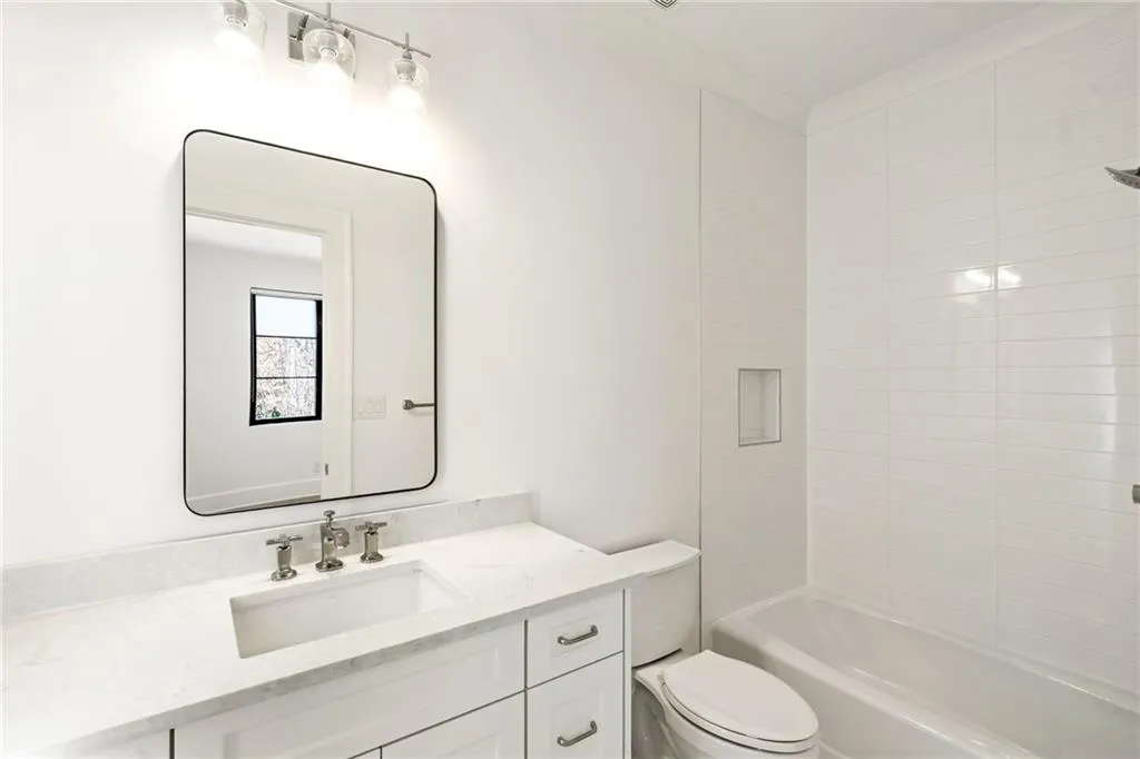 Full bath featuring bathtub / shower combination, vanity, and toilet