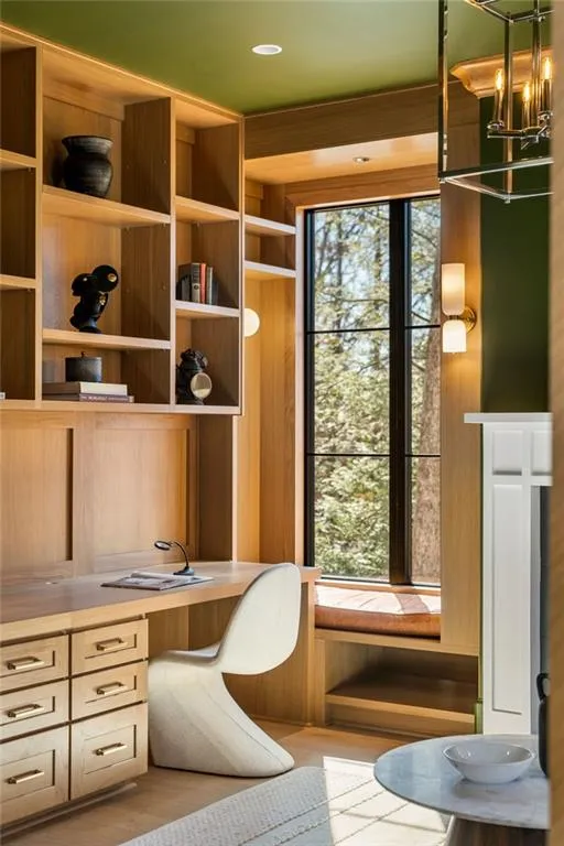 Office featuring built in desk, wood finished floors, and a wealth of natural light