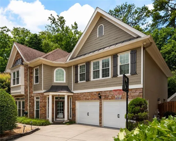 Spacious two-story residence featuring stone and siding exterior