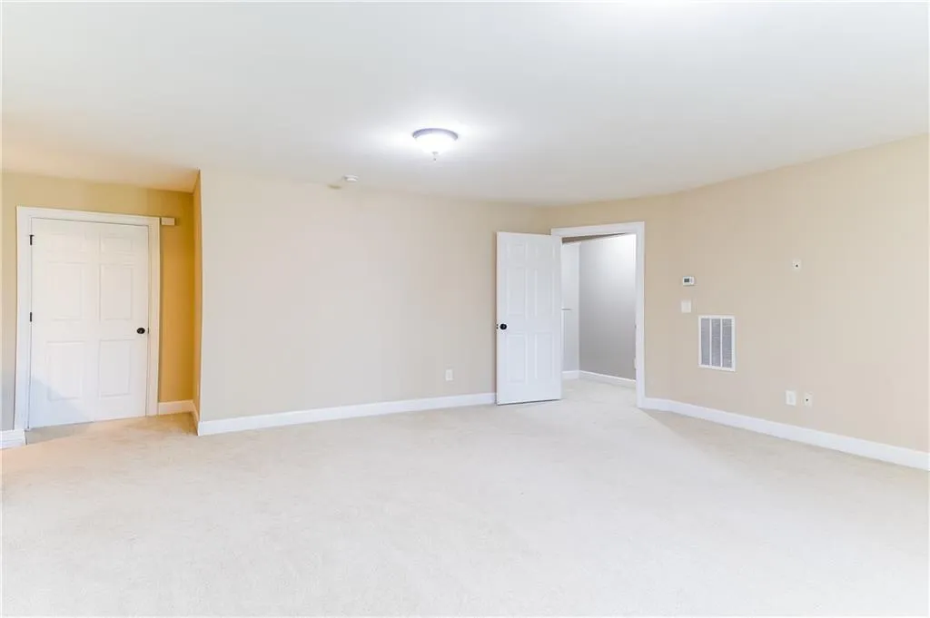 Spare room featuring light carpet