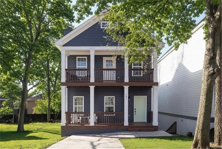 Two-story residence featuring dark blue siding and white trim