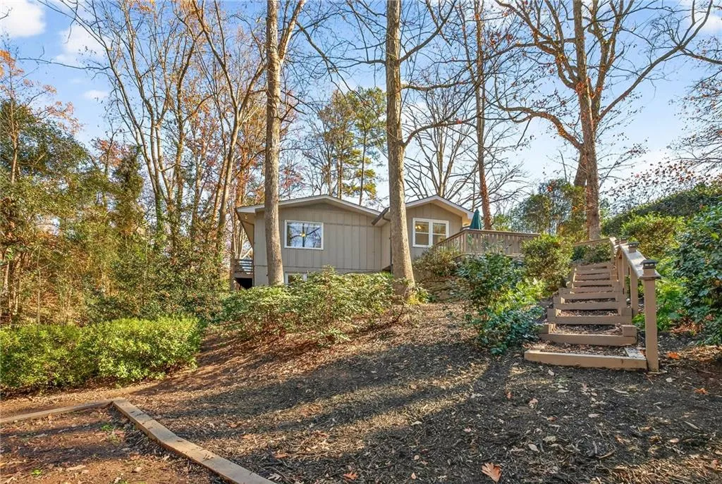 Rear Yard View | Leveled for Optional Firepit or Playset | Professional Hardscaping | Wooded Views | Tranquil Babbling Brook