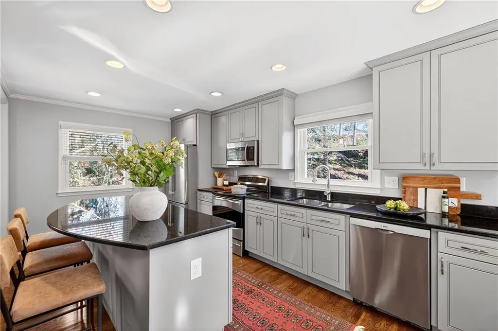 Kitchen Island Seating + Storage | Stone Counters | Wooded Views | Custom Cabinets | Silent Bosch Dishwasher | Storage | Custom Window Treatments