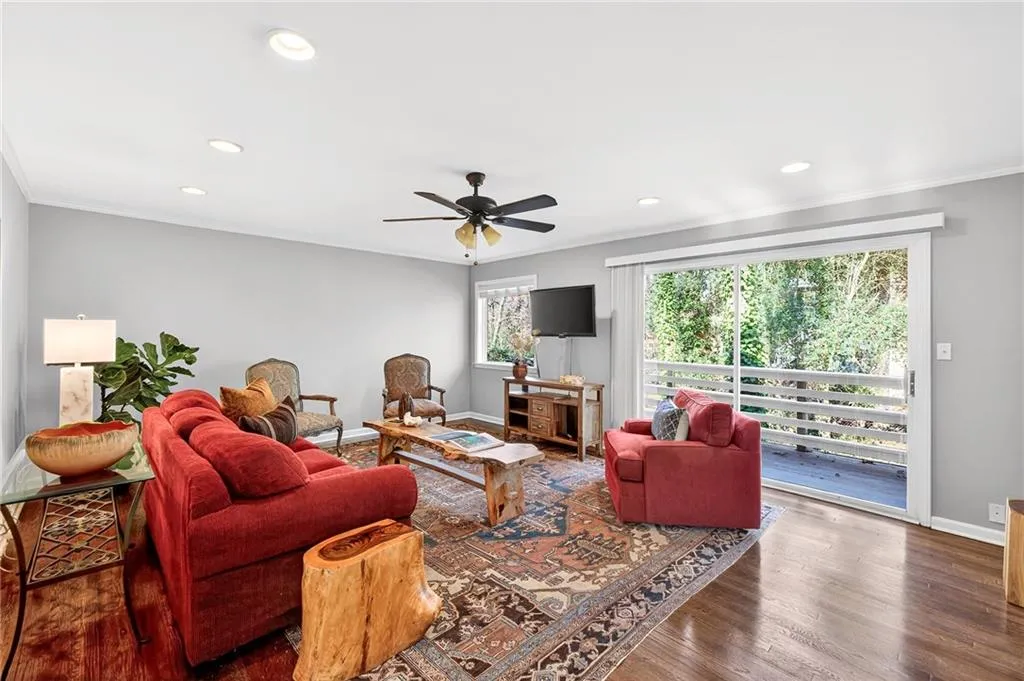 Main Floor Living Room | Wooded Views + Grilling Terrace | Alfresco Dining | Bright Natural Light | Custom Recessed Lighting | Gleaming Hardwood Floors | Floor to Ceiling Gliding Doors