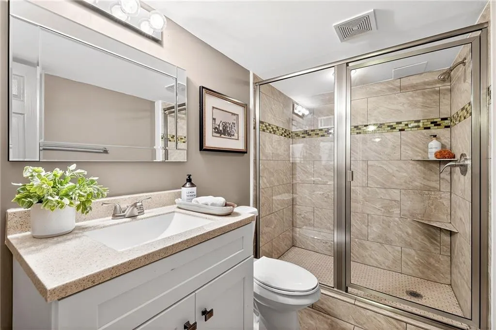 Spacious Renovated Terrace Bath | Neutral Tile | Custom Corner Shower Shelves | Custom Vanity Storage