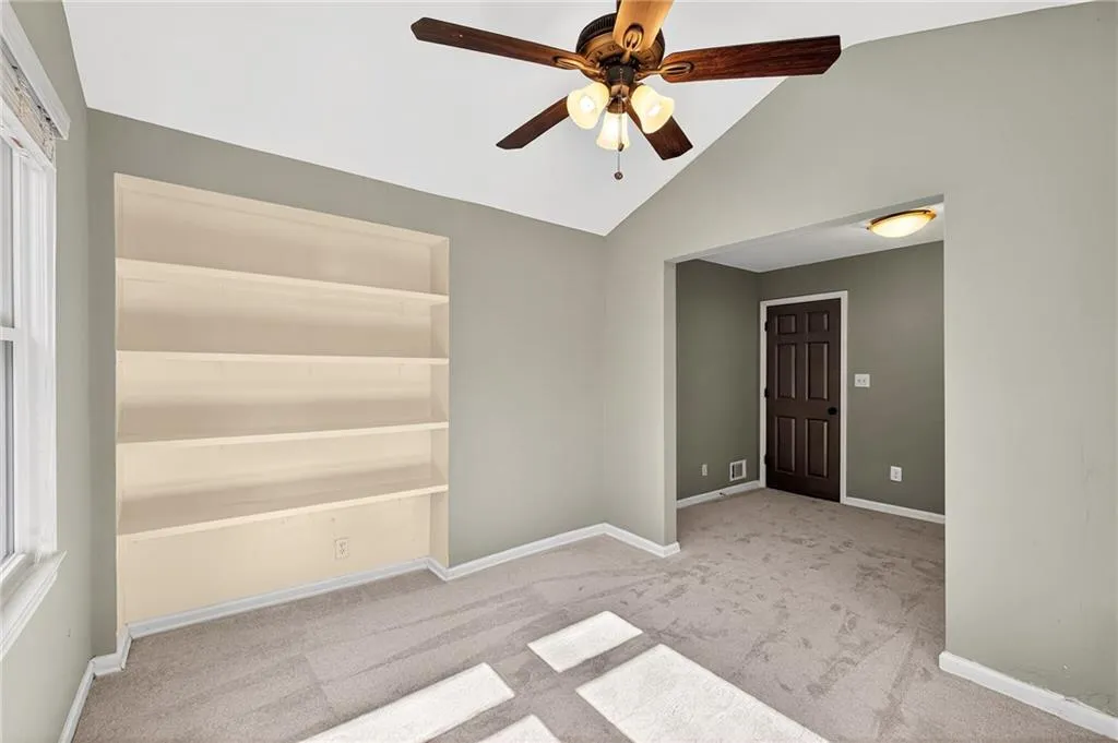 Secondary Bedroom Custom Built-Ins | Neutral Paint | Accent Door | Vaulted Ceiling