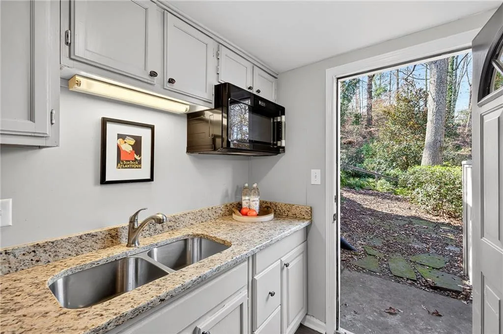 Terrace Level Kitchen | Direct Access to Rear Landscaped Yard | Stone Countertops | Storage