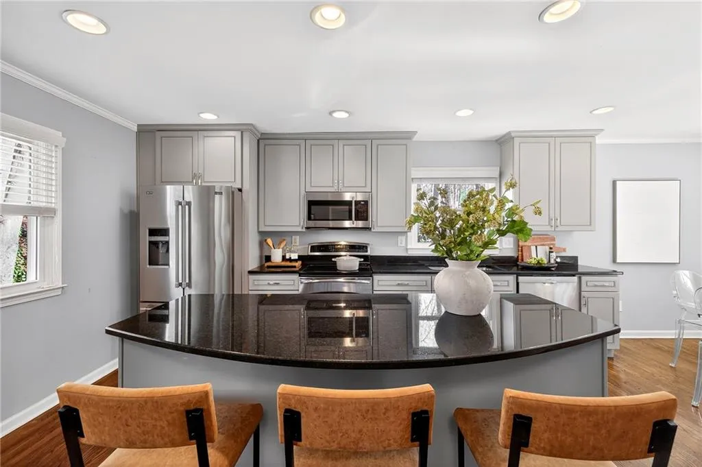 Renovated Kitchen | Custom Soft Close Cabinets, Doors + Drawers | Stainless Steel Appliances | Bright Natural Light | Recessed Lighting | Island Seating + Storage