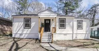 White siding exterior with black-framed windows