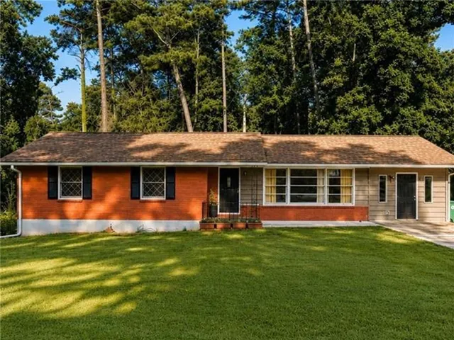 Brick and siding exterior with a brown shingle roof