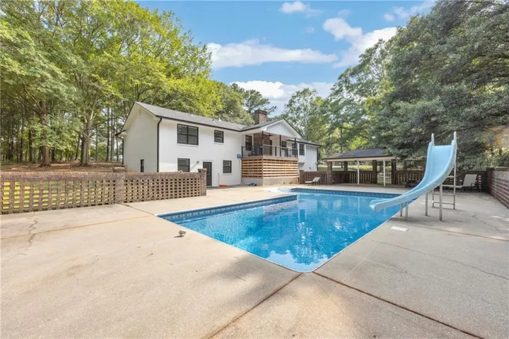 Expansive concrete pool deck surrounding an in-ground swimming pool
