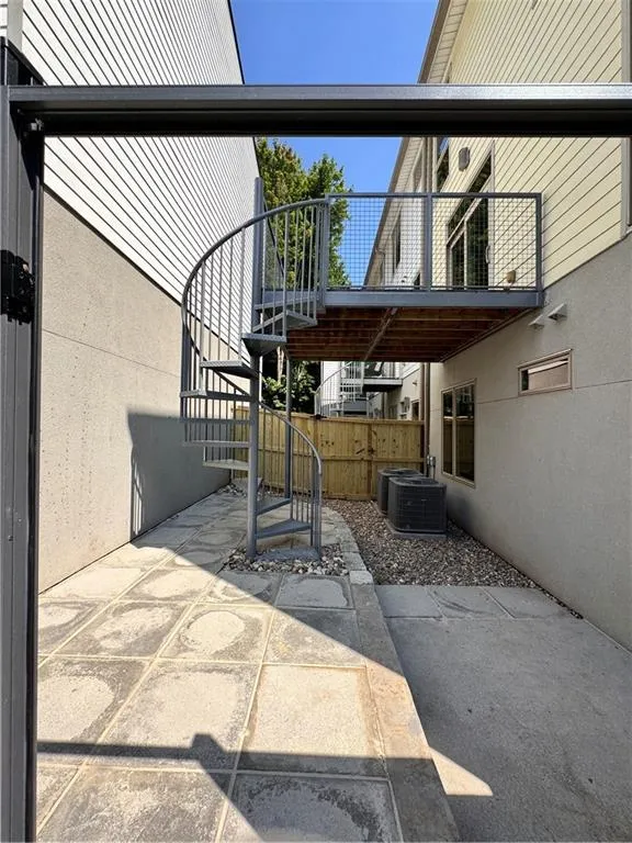 View of patio featuring stairs to deck