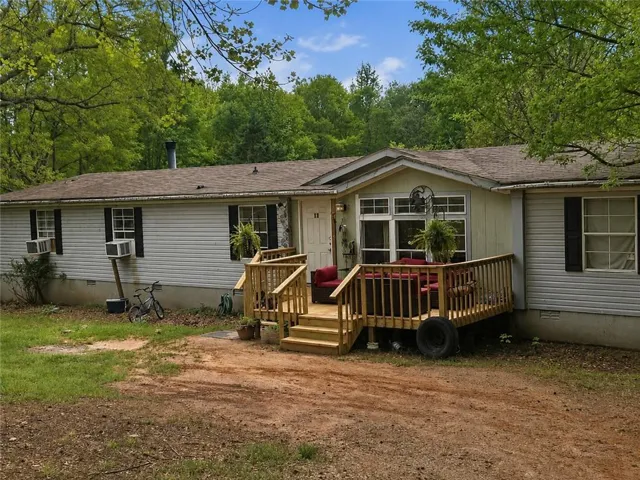 Front exterior featuring white vinyl siding and a neutral-toned roof