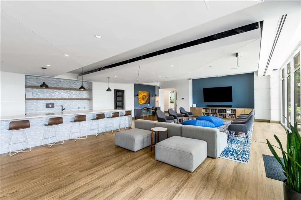 Living room featuring light wood-style flooring and recessed lighting