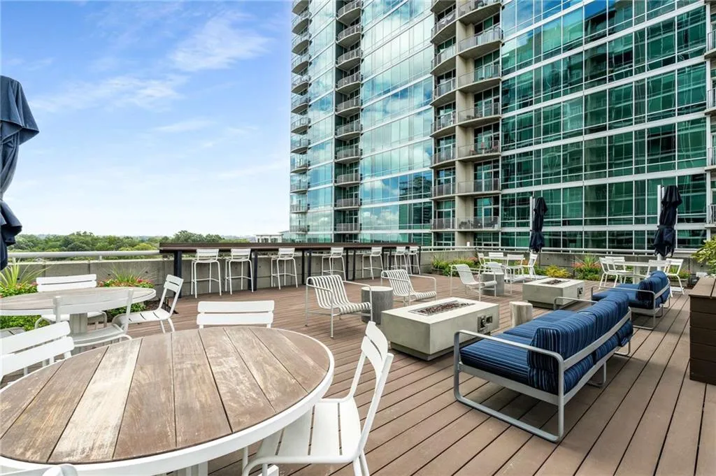 Wooden deck featuring outdoor dining space and an outdoor fire pit