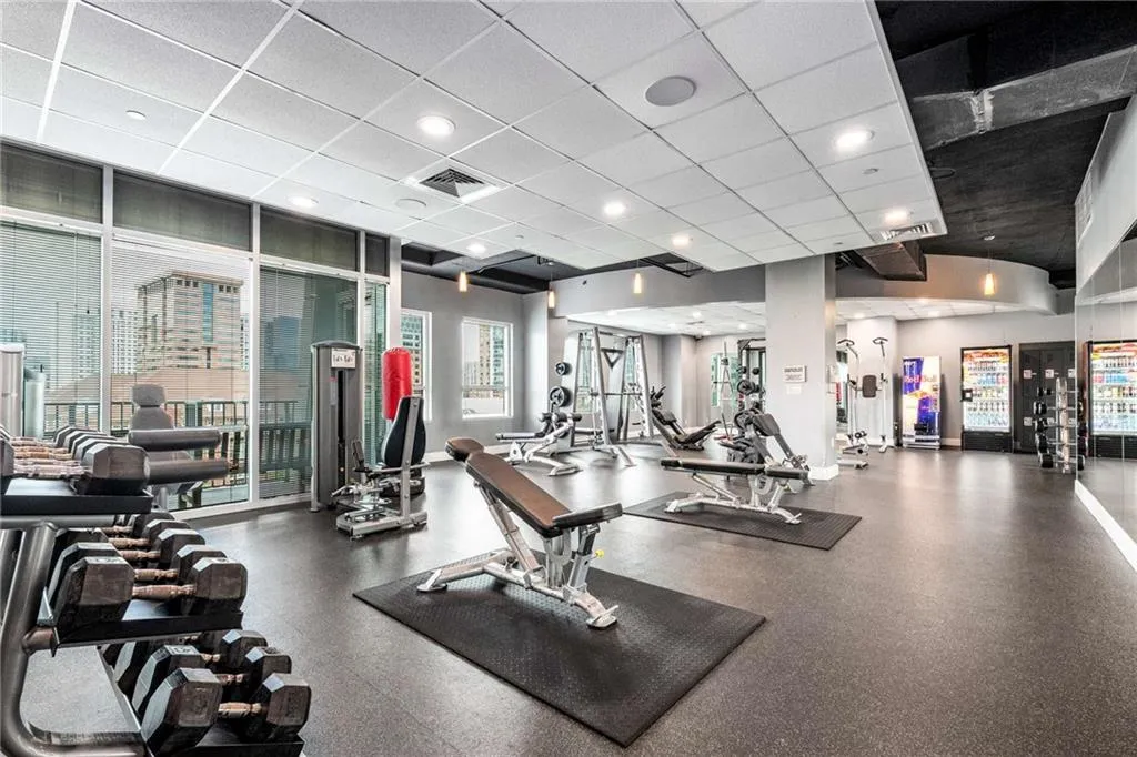 Workout area with a paneled ceiling, recessed lighting, and floor to ceiling windows