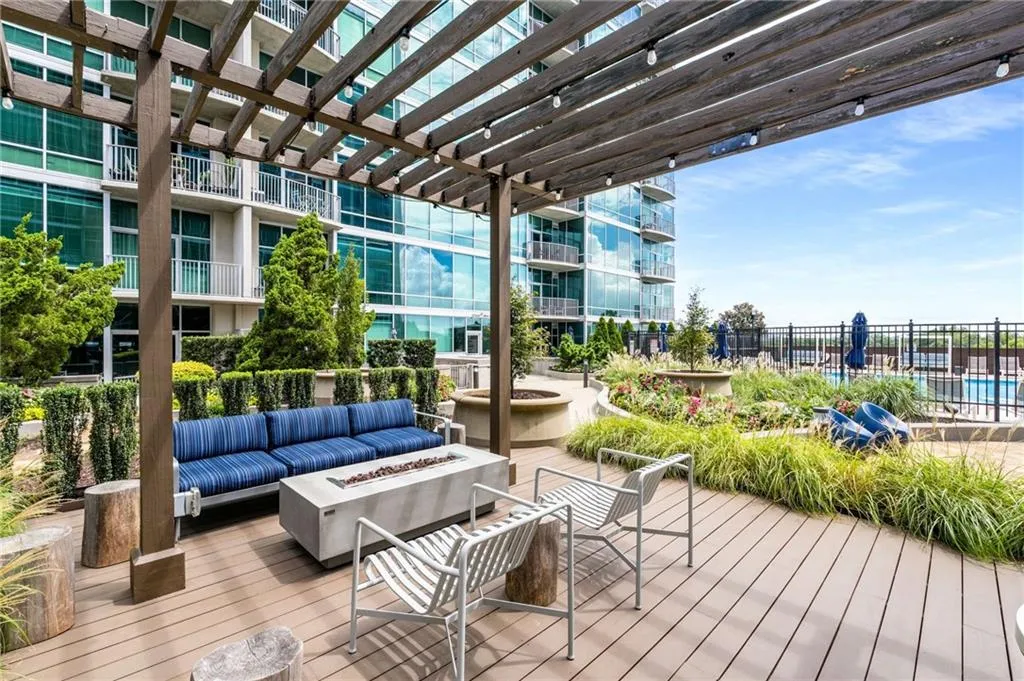Wooden terrace with a fire pit and a pergola