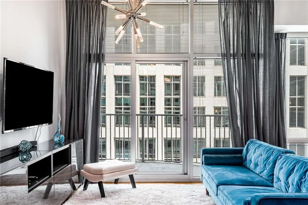 Carpeted living room with a chandelier