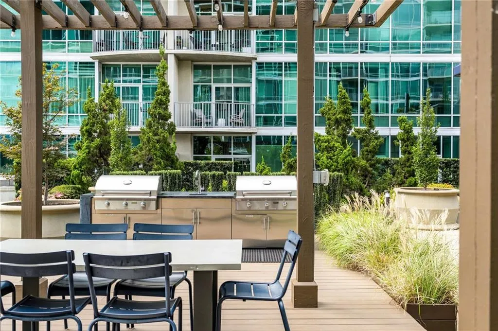 View of property's community featuring outdoor dining space and an outdoor kitchen