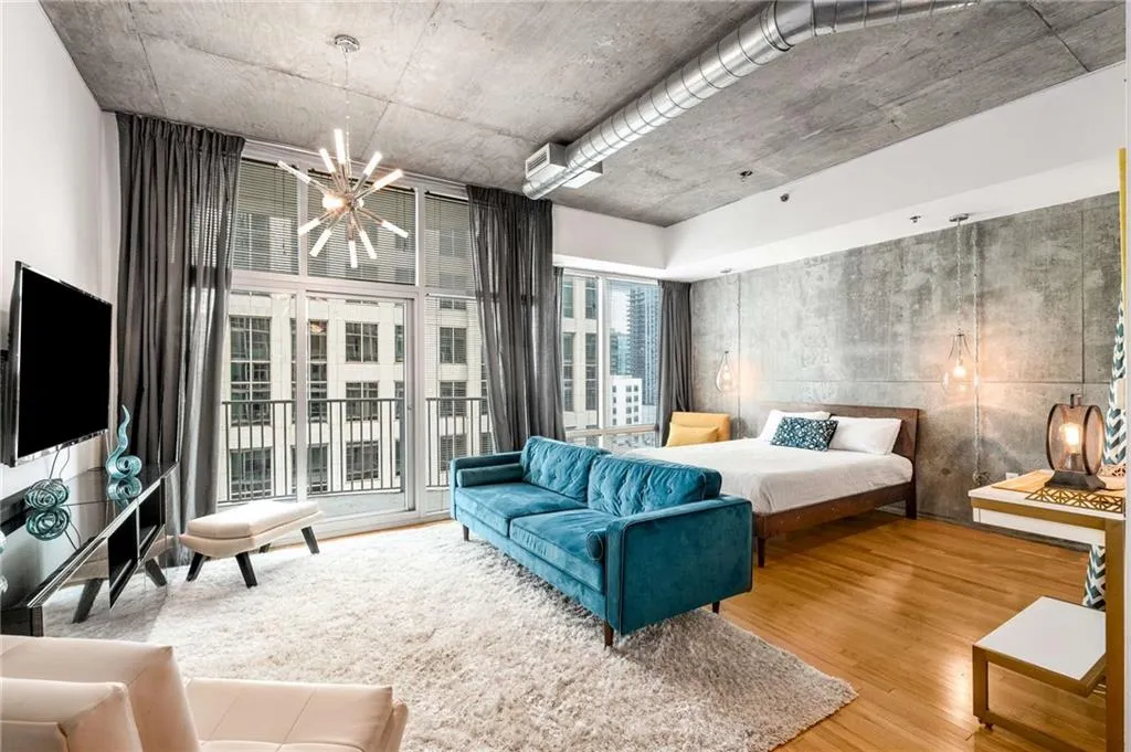 Bedroom featuring wood finished floors and a chandelier