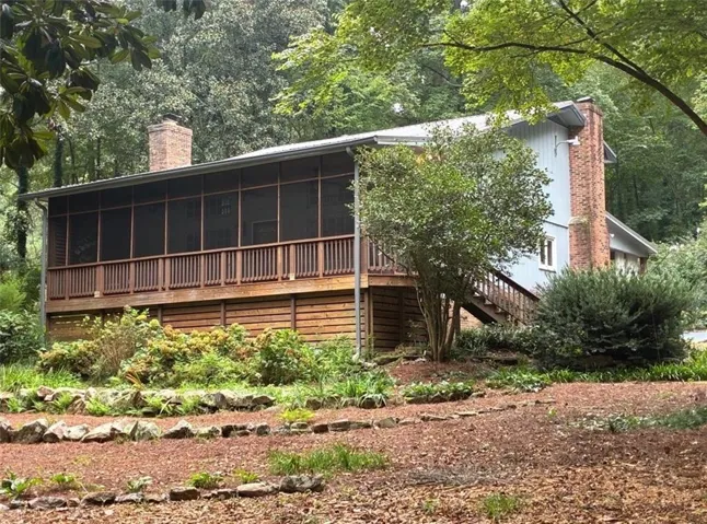 Expansive screened porch with wood railings and decking