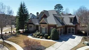 Brick and stone exterior with a multi-gabled roofline