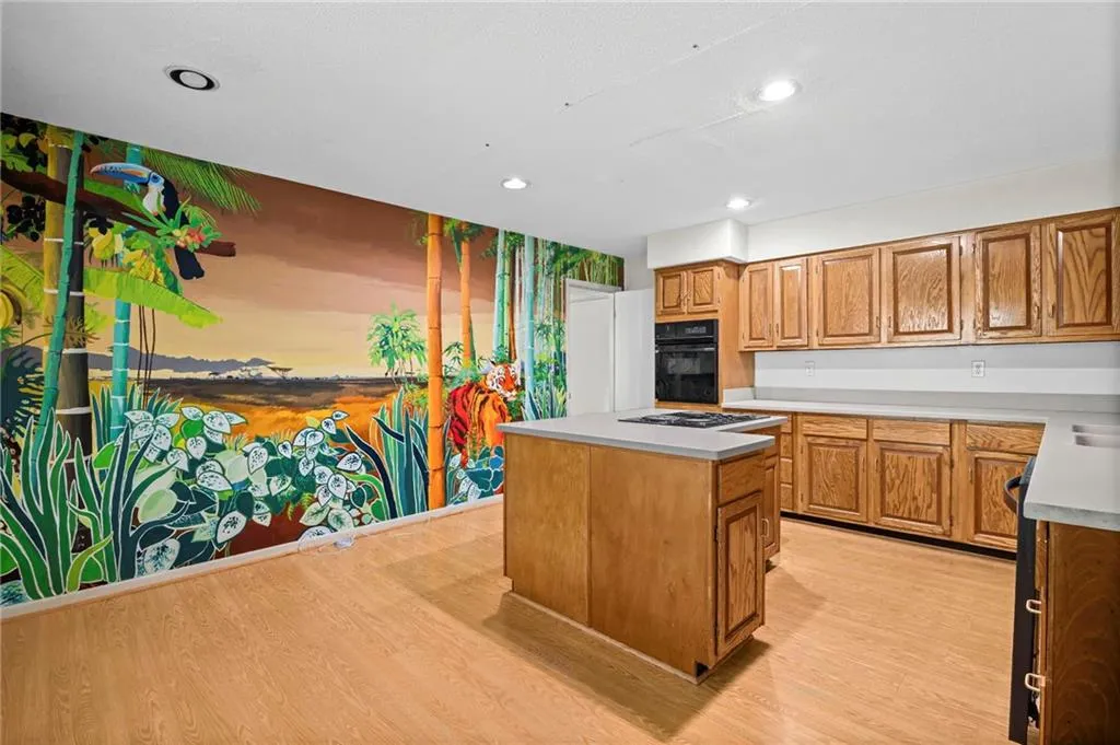 solid wood cabinetry. L shaped island and handpainted mural