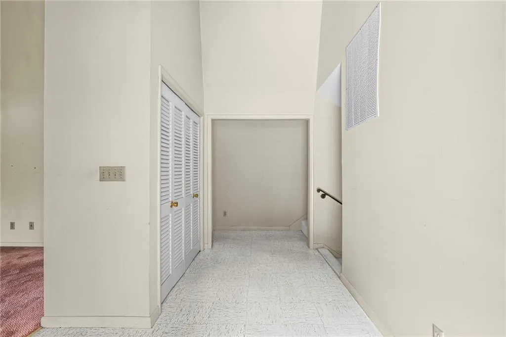 Double front doors lead to extra wide entrance foyer with tall ceilings and coat closet