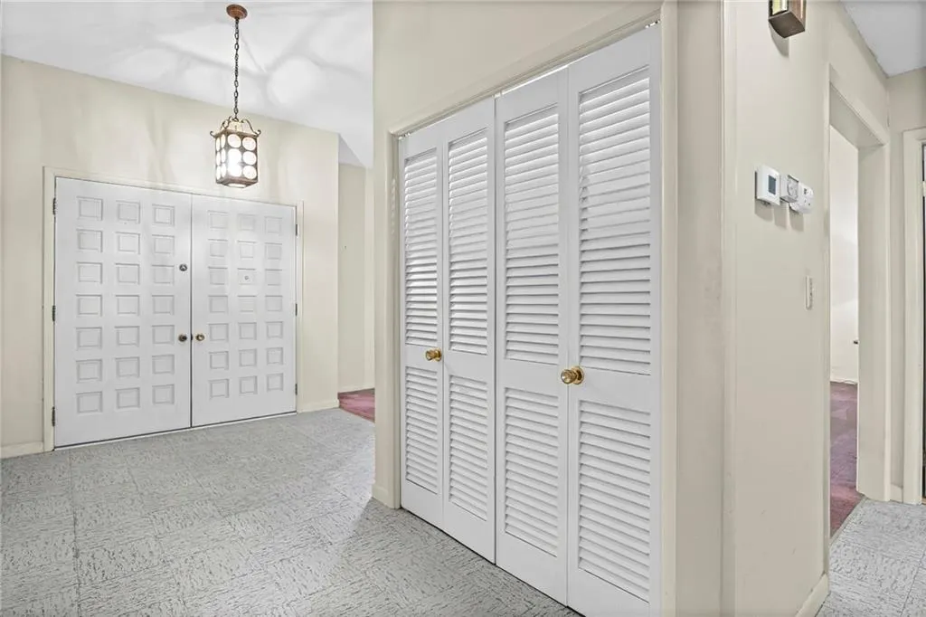 Entry Foyer has solid wood double doors, tall ceilings and double closet