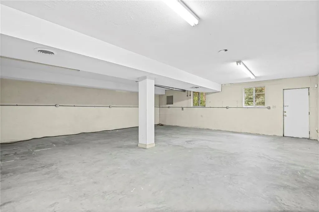 Large Finished basement level has concrete floors, windows, and exterior access