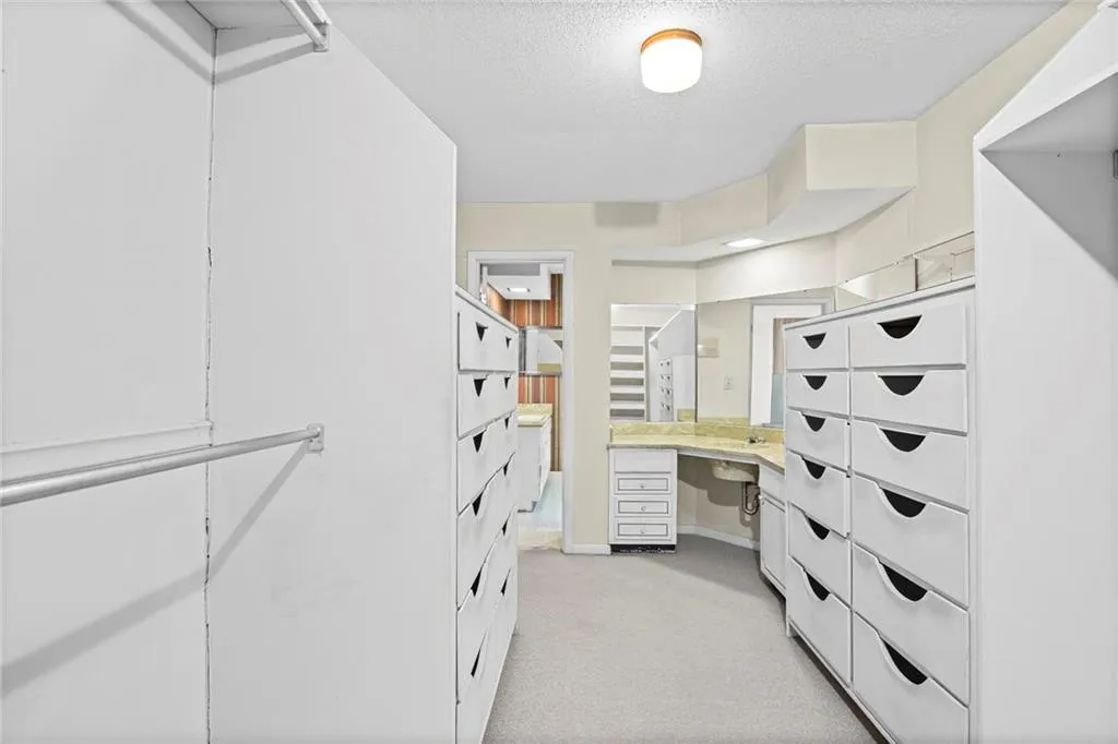 Large walk in closet in Primary has vanity area