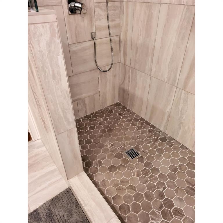 Bathroom with tile floors and a shower