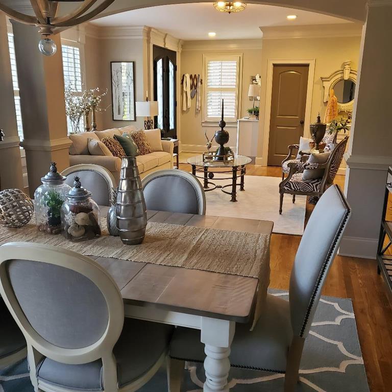Dining area featuring hardwood / wood-style floors, a wealth of natural light, and crown molding