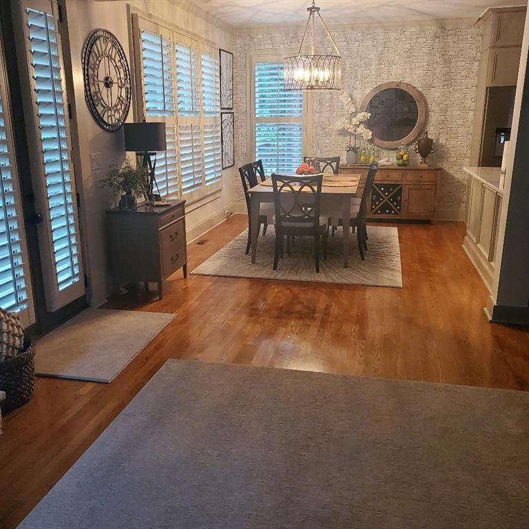 Dining area with wood-type flooring and a chandelier