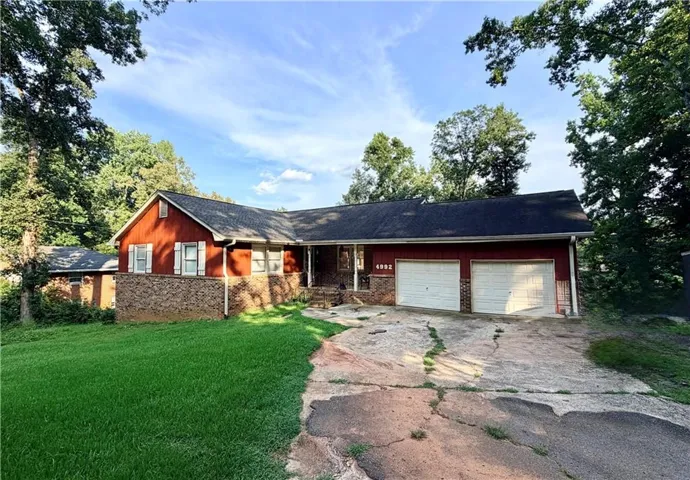 Ranch-style exterior with red siding and stone accents