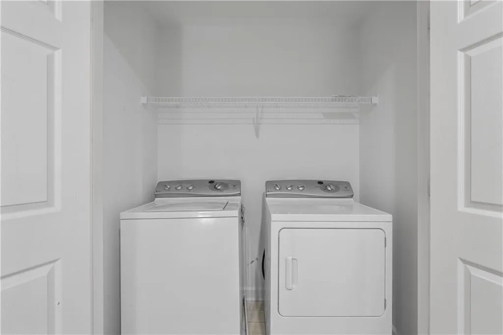 Washroom featuring independent washer and dryer