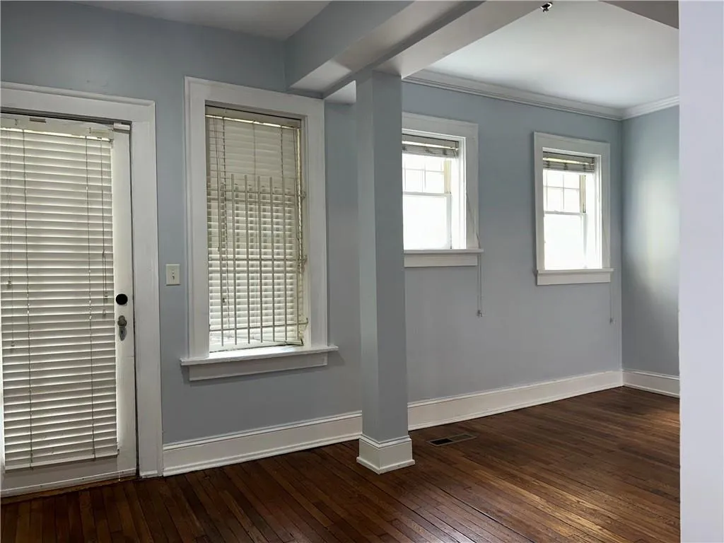 Entrance foyer featuring baseboards, hardwood / wood-style floors, and crown molding