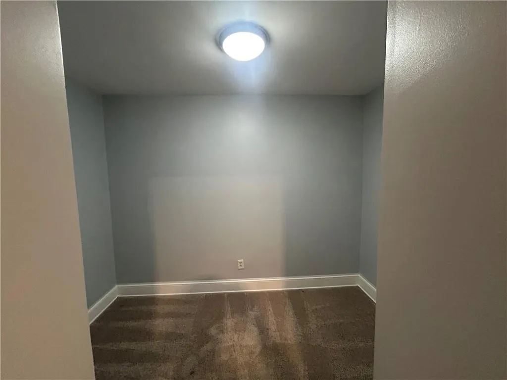 Spare room with carpet floors and baseboards