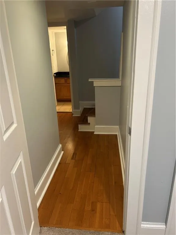 Hallway with wood finished floors and baseboards