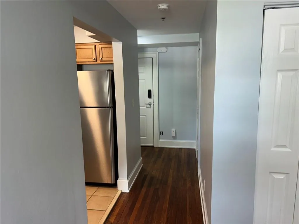 Corridor with wood finished floors and baseboards