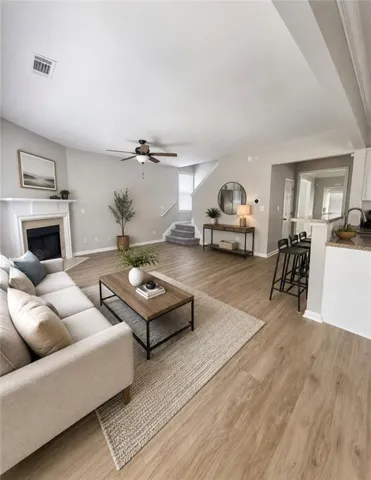 Open-concept living space featuring wood-finish flooring throughout