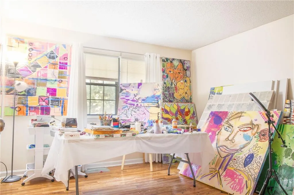Playroom featuring a textured ceiling and wood-type flooring