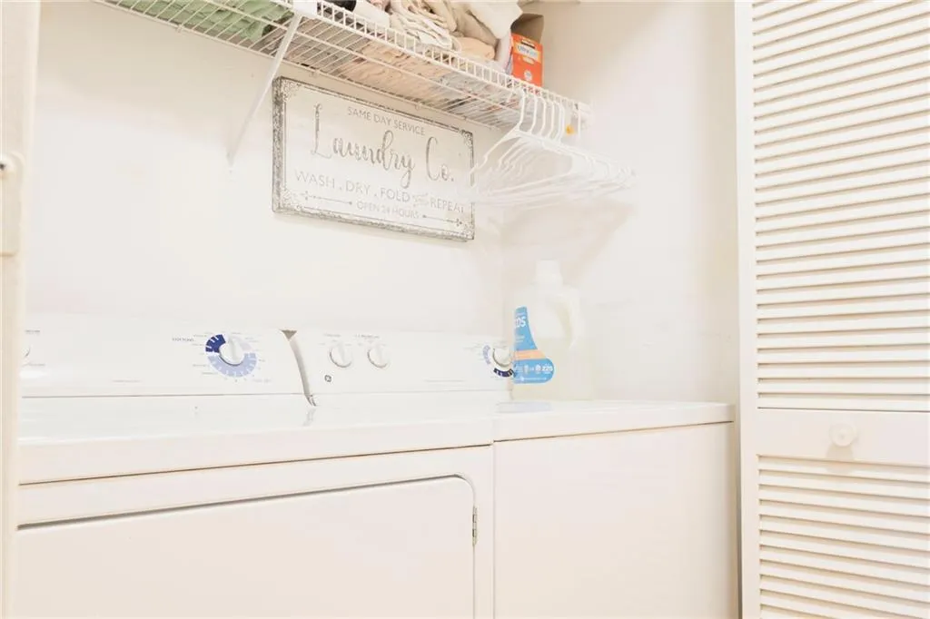 Washroom with washer and clothes dryer